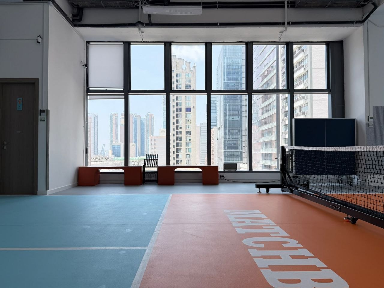 Floor-to-ceiling windows with the bench seating between games