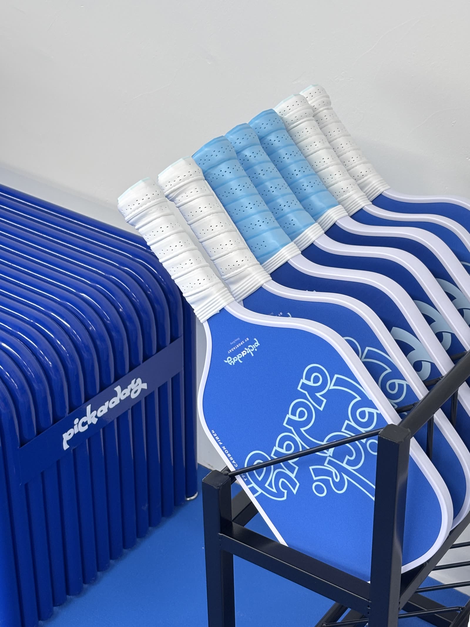 Branded carbon-fibre rental paddles on the rack