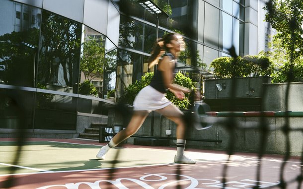 Full-size court framed by the hotel tower