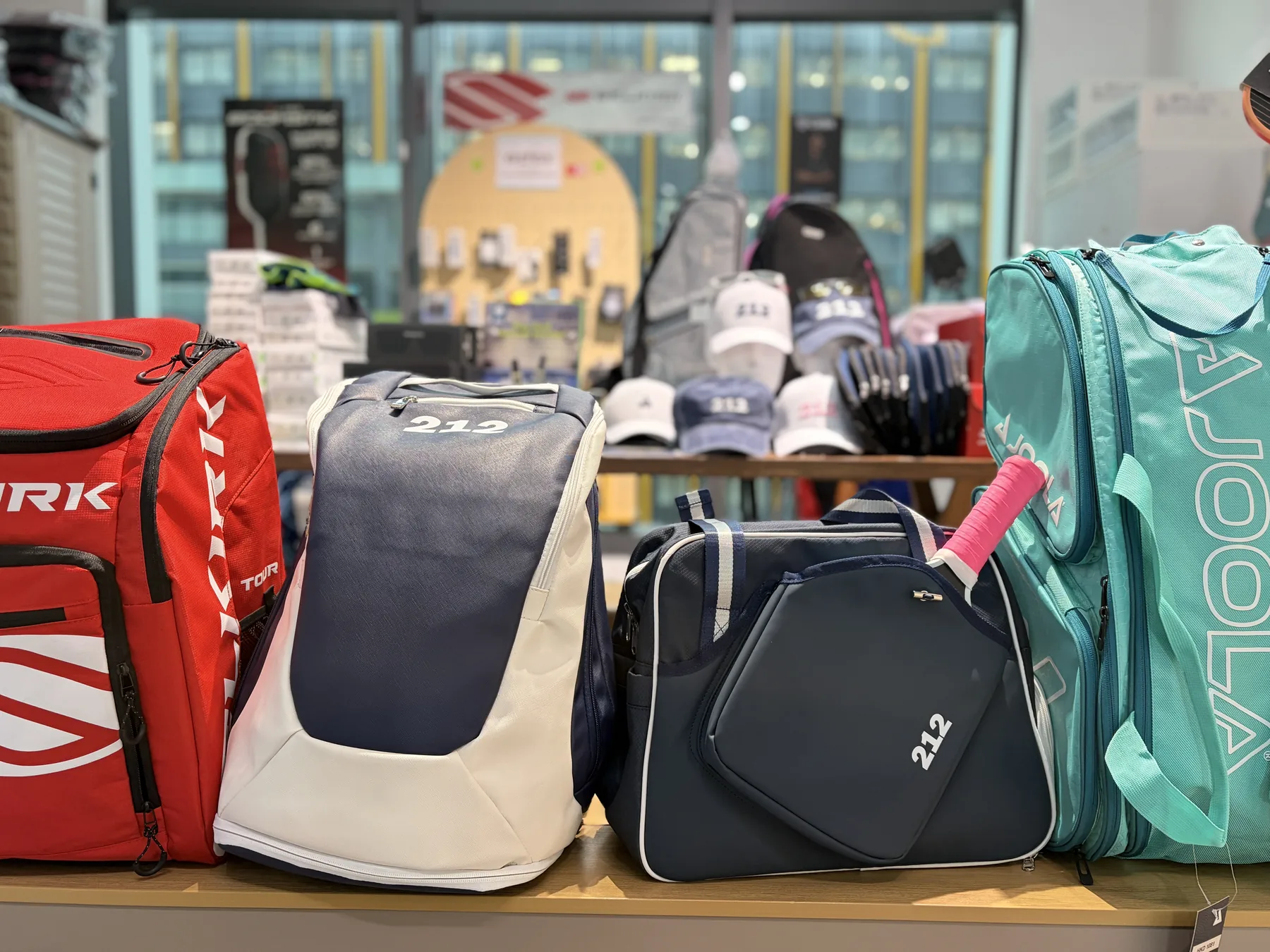 212HK and JOOLA pickleball bags displayed in the SmashPoint store