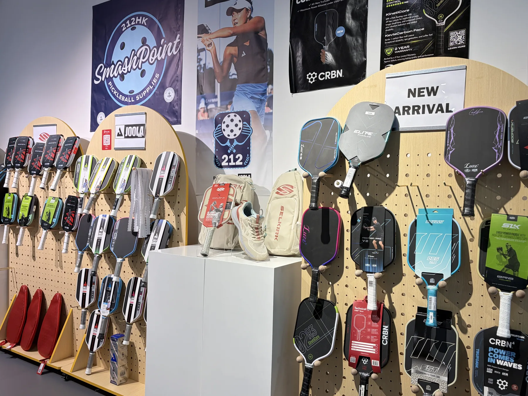 SmashPoint paddle wall with JOOLA, Selkirk and CRBN paddles