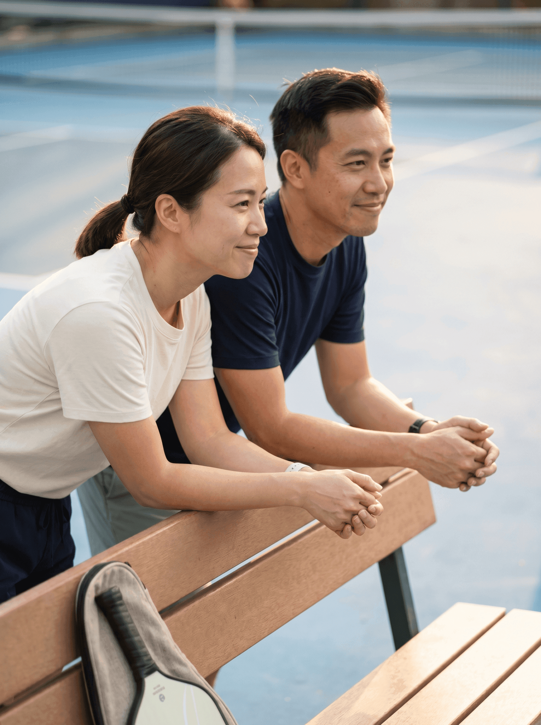 Parent sitting courtside watching their kid practice