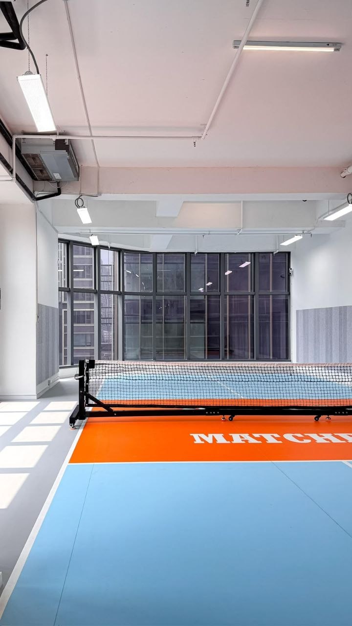 Orange-and-blue acrylic court under 4.5 m ceilings
