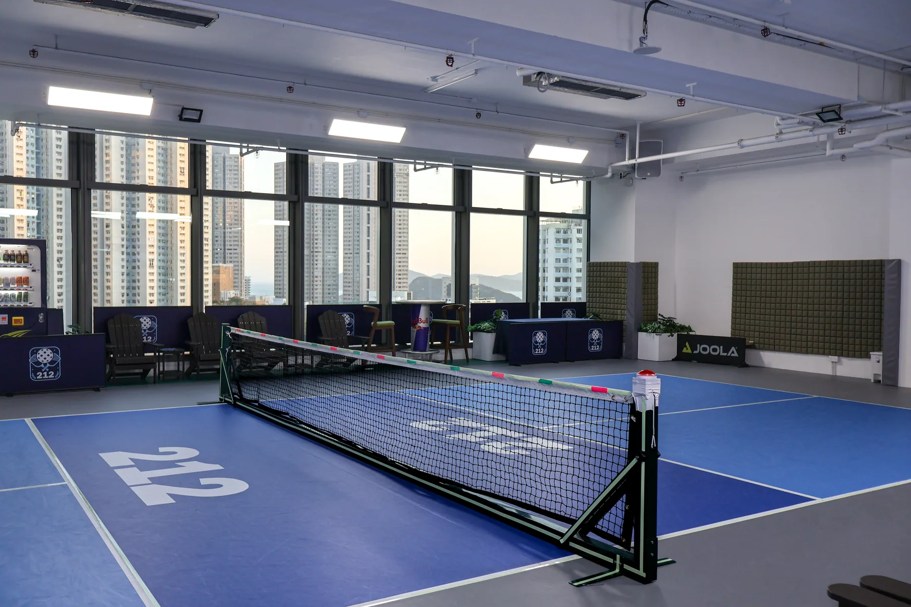 A 212HK pickleball court framed by floor-to-ceiling windows overlooking Wong Chuk Hang