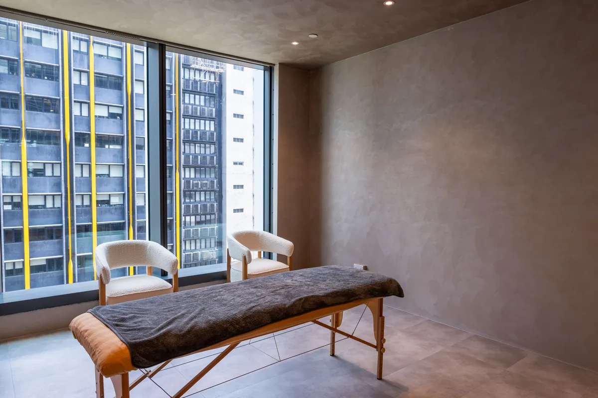 Recovery room with a massage table overlooking Wong Chuk Hang