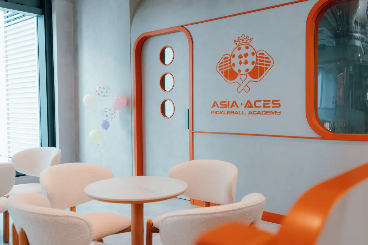 Retro viewing pod and café seating beside the court
