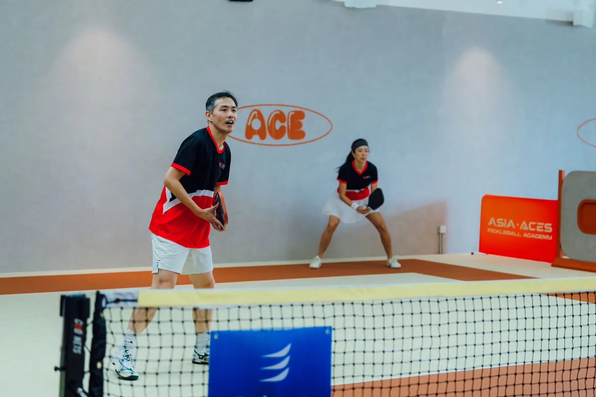 Corporate league doubles rally at the net